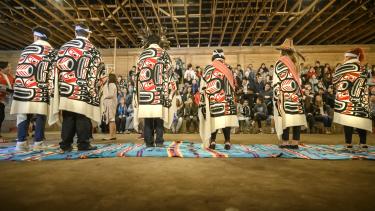 2019 Aboriginal Role Model Honouring Six Aboriginal role models stand on blankets in the longhouse