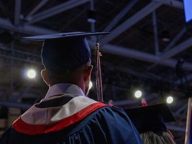 Back of the head of a graduate as they look out into the audience
