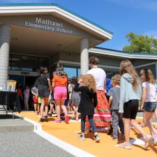 Students and teachers walking along the crosswalk after the official opening