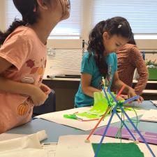 Two female students working on early literacy projects