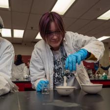 Two students completing a science experiment