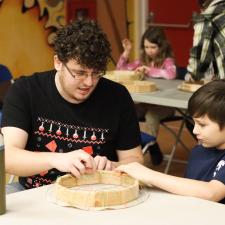 Indigenous Support Worker, supporting student with drum making