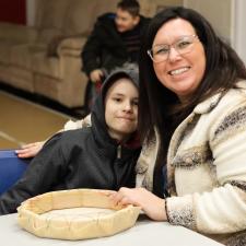 ISW and Indigenous student smile with their drum