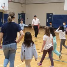 Metis Jigger demonstrating to an elementary class in the gym