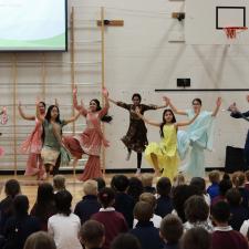 Bhangra Dancers performing in front of elementary students in gym