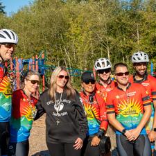 Tour de Valley riders pose for photo with Auguston staff member.